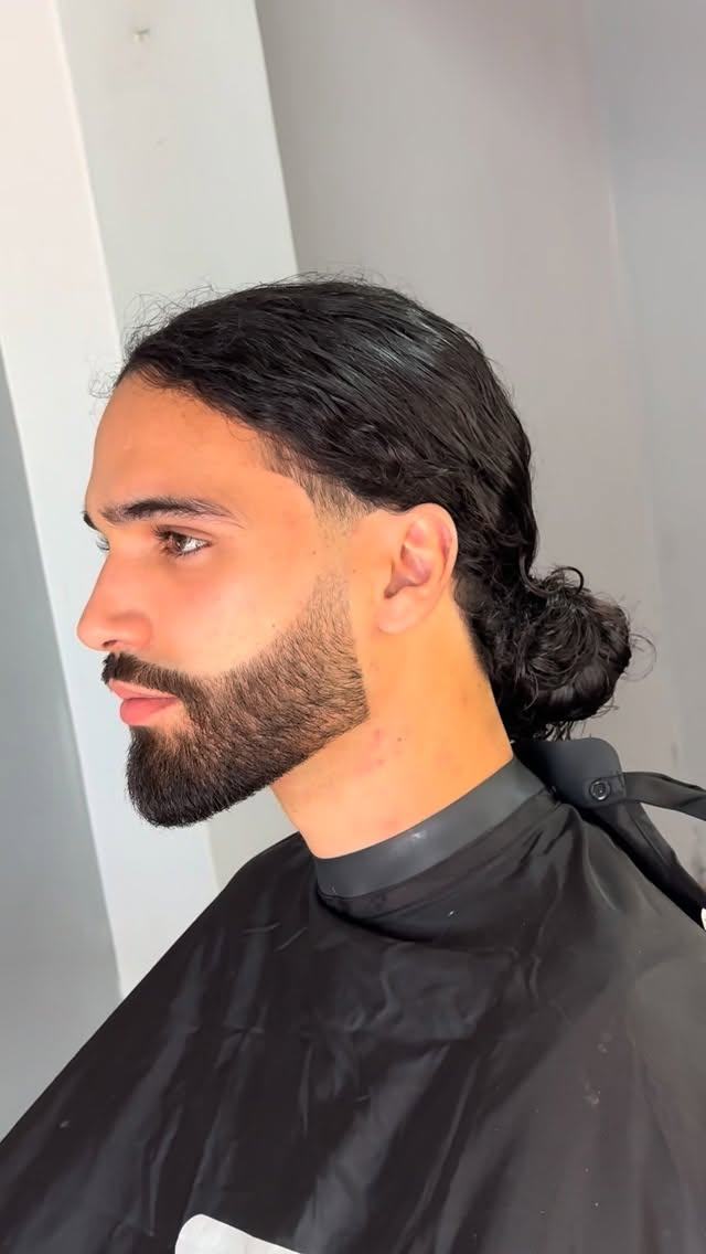 Cabelo comprido apanhado com barba alinhada